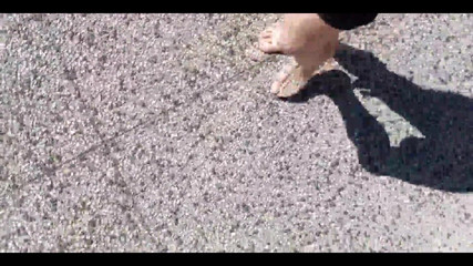 Jon Arteen Walks Barefoot on the Street Outdoors, the Boy Is Barefoot in the Crowded Tram to the Town Center