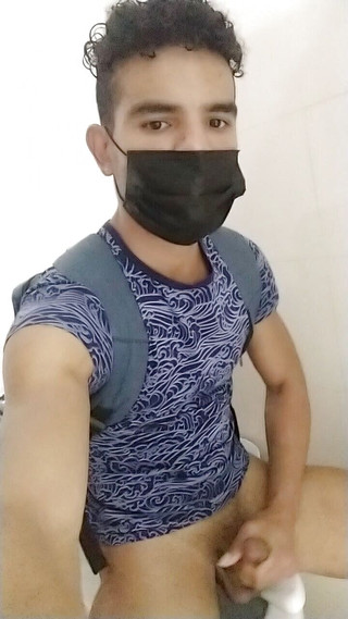 Young gay Latino in bathroom