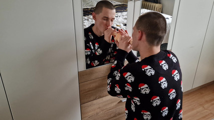 Naughty young horny Stepdaddy sucking big dildo in front of mirror dressed in Christmas sweater ...